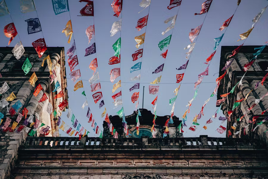 Colorful papel picado banners against the sky